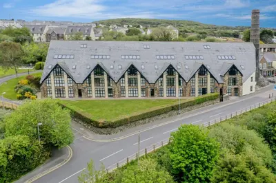 a large building with a road in front of it at Pochin House Collections in St Austell