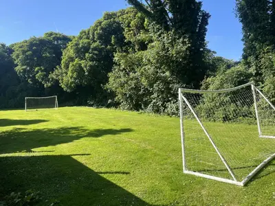 two soccer nets in a field with trees at Aval Dor Barn, Hot Tub, Pet Friendly in Ludgvan