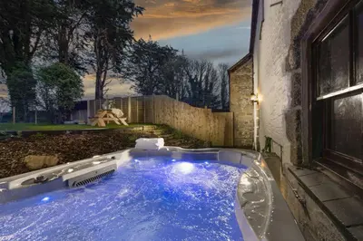 a hot tub in the backyard of a house at Aval Dor Barn, Hot Tub, Pet Friendly in Ludgvan