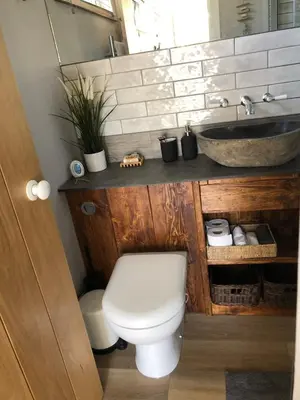 a bathroom with a toilet and a sink at Piala retreat in Phillack