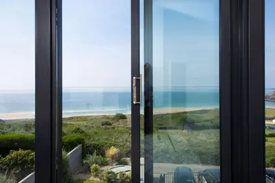 a window with a view of the ocean at Ocean View, The Sands in Praa Sands
