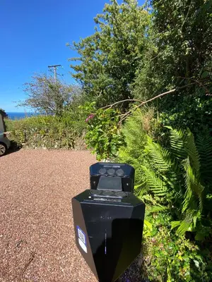 a parking meter sitting on the side of a road at Polrunny Farm Seaberry Cottage with a sea view and log burner in Boscastle