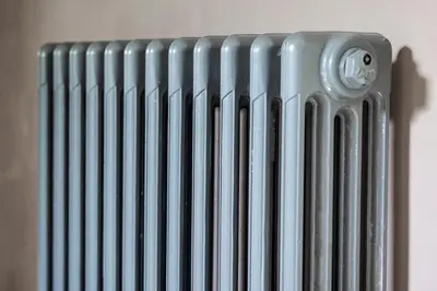a radiator sitting on a wall with its shadow at Cusgarne Manor boutique B&B - adults only in Cusgarne