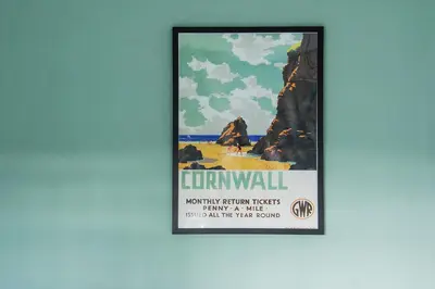 a framed poster of a beach and rocks at Cusgarne Manor boutique B&B - adults only in Cusgarne