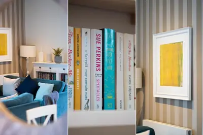 a book shelf filled with books in a living room at Porthminster Mews in St Ives