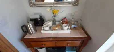 a table with cups and cups on top of it at Trewethen Cottage Barn 1 near Port Isaac in Port Isaac