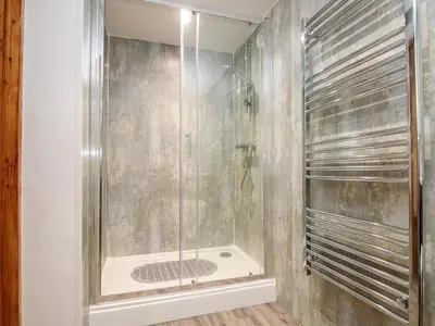 a shower with a glass door in a bathroom at The LinneyThe West Dry in St Austell