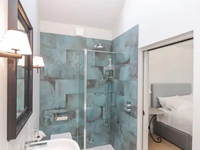 a bathroom with a glass shower with a sink at Wood Meadow in Helston