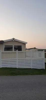 a white fence in front of a house at 58 Newquay View, Newquay Bay Resort in Porth