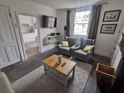 a living room with a couch and a table at Malahne Apartment Port Isaac in Port Isaac