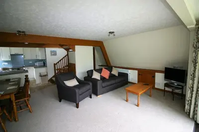 a living room with a couch and a table at Lodges in Lanivet Cornwall with indoor pool in Bodmin
