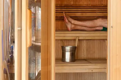 a persons feet in a wooden cupboard with a leg in it at PointBreak Sleeps 12 with hot tub-Great celebration house-Dog friendly in Padstow