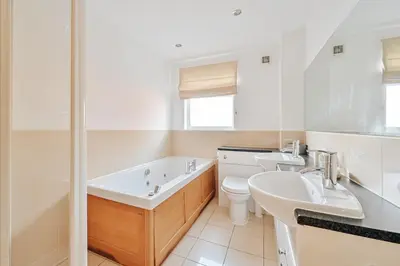 a bathroom with two sinks and a tub and a toilet at Swallow Lodge with Hot Tub, dogs welcome sleeps 8, Great resort Facilities in Padstow