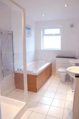 a bathroom with a tub and a toilet and a sink at Retallack Resort 4 bedroom lodge - Hot Tub for hire on request -Pool & Spa in Padstow