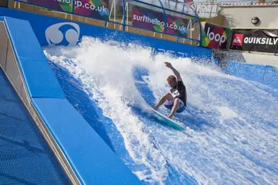 a man riding a wave on a surfboard in a wave tunnel at Retallack Resort 4 bedroom lodge - Hot Tub for hire on request -Pool & Spa in Padstow
