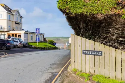 a sign on a fence on the side of a road at Westward 8 in Polzeath
