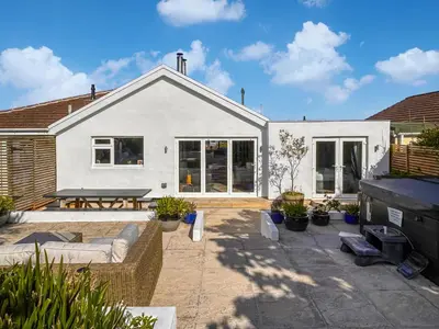 a house with a patio with a table and chairs at Villa Calafia - Uk38491 in Porthtowan