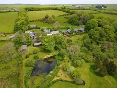 an aerial view of a farm with a pond at Ta Mill Cottages & Lodges - Brookview Lodge 2 in Launceston