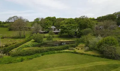 an aerial view of a garden with a house in the background at Ta Mill Cottages & Lodges - Brookview Lodge 3 in Launceston