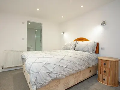 a bedroom with a bed with a wooden head board at Crofty's Celder - Uk35181 in Pool