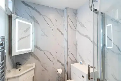 a bathroom with a shower and a sink at Finest Retreats - The Hideaway - Studio Apartment in Porthleven in Porthleven