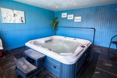 a jacuzzi tub in a blue room at Kerensa in Mawnan