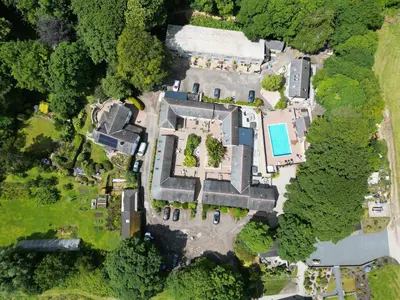 an overhead view of a mansion with a pool at Mousehole in Mawnan