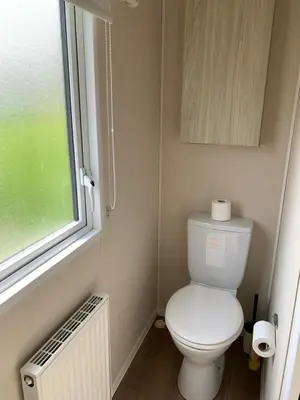 a small bathroom with a toilet and a window at Newquay Bay Resort 63 in Porth