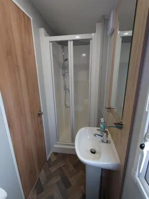 a bathroom with a sink and a shower at White Acre's Holiday Park, 602 Sycamore Forest in Saint Enoder