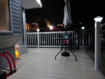 a porch at night with a table and an umbrella at White Acre's Holiday Park, 602 Sycamore Forest in Saint Enoder