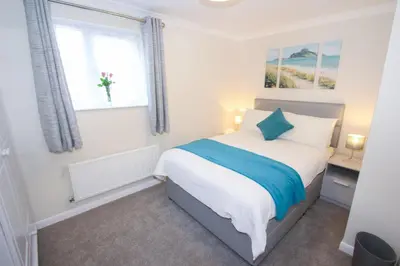a bedroom with a bed and a window at The Laurels Holiday Park & Cottages nr Padstow and Wadebridge in Wadebridge