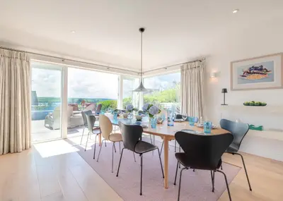 a dining room with a table and chairs at Landers Field in Padstow