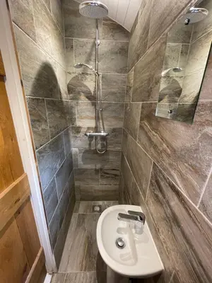a bathroom with a sink and a shower at Hare's Hut in Saint Clement