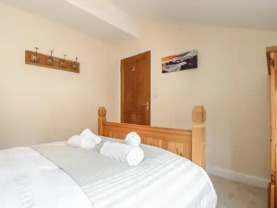 a bedroom with a bed with towels on it at Maple in Falmouth
