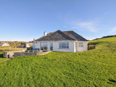 a house on a hill with a green lawn at Upper Gren in Polzeath