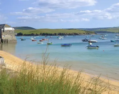 a group of boats in the water on a beach at Seastar in Wadebridge