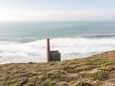a smoke stack on a beach near the ocean at Gwel Nans in St. Agnes