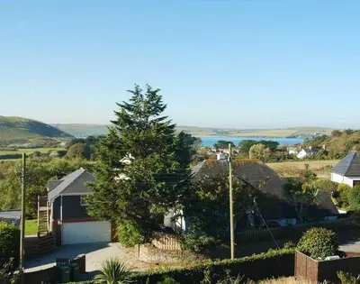 a house with a tree in front of it at Ragleighs in Polzeath