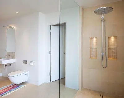 a bathroom with a shower and a toilet and a sink at Downalong in Polzeath