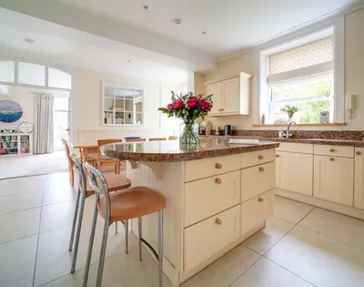 a kitchen with a counter with a vase of flowers on it at The Haven in Polzeath