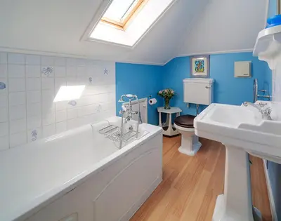 a bathroom with two sinks and a tub and a toilet at The Haven in Polzeath