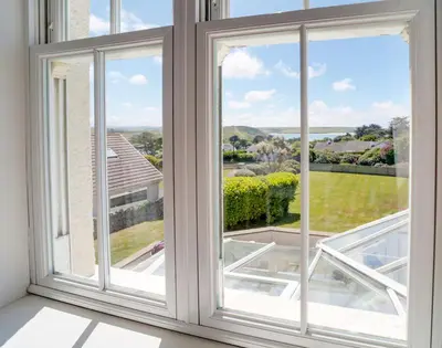 an open window with a view of a yard at The Haven in Polzeath