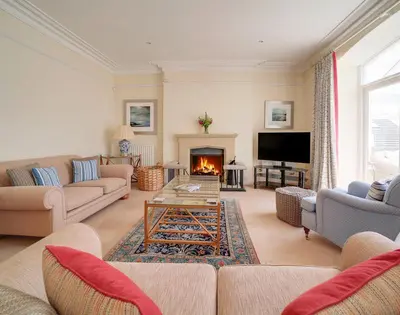 a living room with couches and a fire place at The Haven in Polzeath