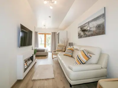a living room with a white couch and a tv at Westfields in Launceston