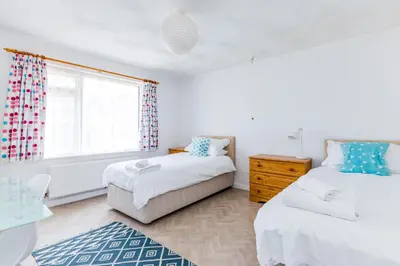 a bedroom with two beds and a window at Bella Vista in Polzeath