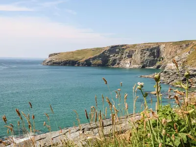 a view of a body of water with a cliff at 4 Trerammet Crescent in Tintagel