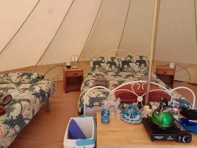 a room with two beds and a tent at Cornish Skies Glamping in Pool
