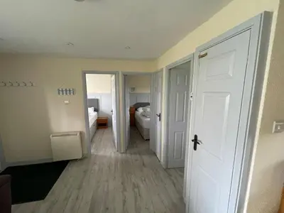 a room with a hallway with a bedroom and a door at 81 Hengar Manor in Bodmin