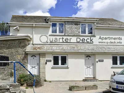 a white building with a sign for a vendor desk at Trenpeskador - Uk39442 in Saint Columb Minor
