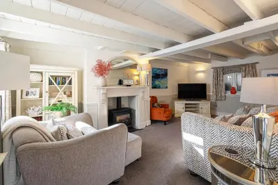 a living room with couches and a fireplace at Beautiful 3 bedroom cottage in the heart of Looe in Looe